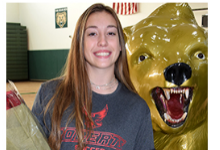 Senior Soccer player Courtney Seery stands next to the Vestal Golden Bear statue prior to her signing ceremony in the Vestal High School gym on November 10, 2021.