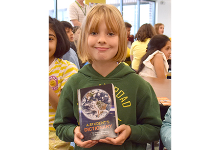 An African Road Elementary third-grader holds the new dictionary she received from the Vestal Elks on October 24, 2023.