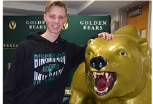 Vestal High School senior Timothy Smith next to the Vestal Golden Bear prior to his national letter of intent signing ceremony on December 20, 2022.