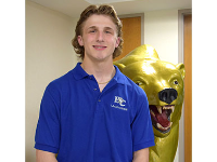 Christopher Tomcho by the Vestal Golden Bear statue in the Vestal High School lobby.