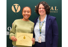 A Vestal High School senior holds her Student Recognition certificate as she stands next to Principal Young.