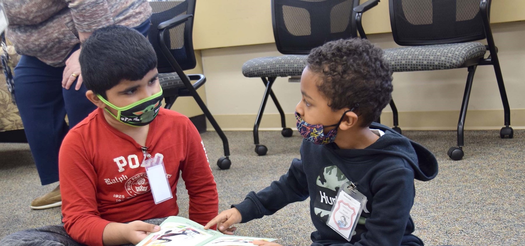 Two first-grade boys from Vestal Hills Elementary read a book together while on a Word Detectives adventure to the Super-Secret Detective Agency.