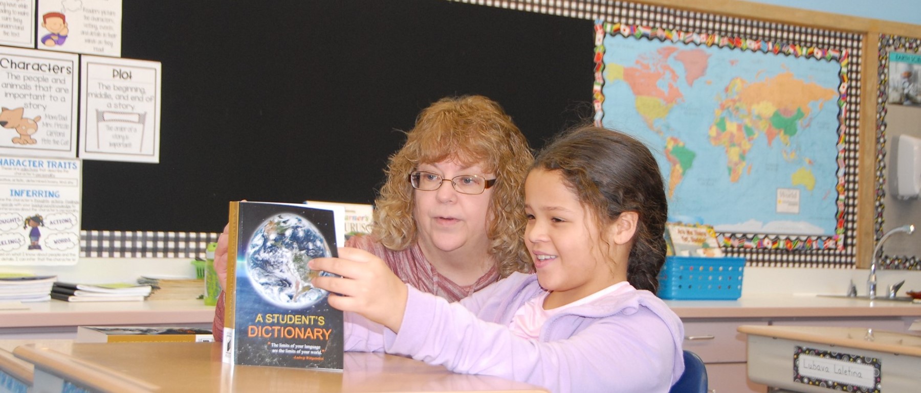 A third-grade teacher at Clayton Avenue Elementary helps one of her students navigate how to use the new dictionary she just received from the Vestal Elks.