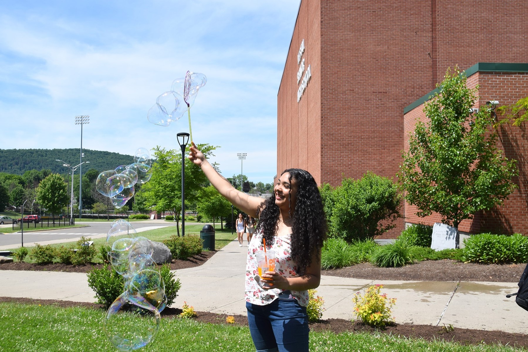 A Vestal High School girl creates bubbles with a wand on Destress Day, June 14, 2022.