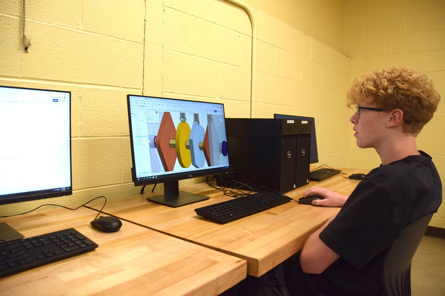 A Vestal High School boy manipulates a mouse as he finishes up a C A D  design in his Project Lead the Way class in June 2022.