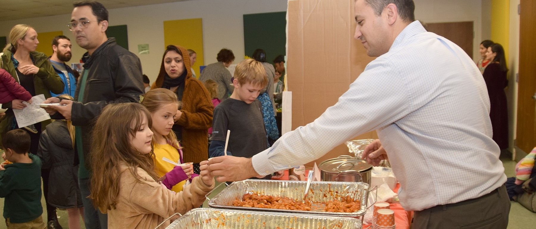 Two African Road Elementary students stop by the table representing Italy during the Taste of A R E  event on November 14, 2023.