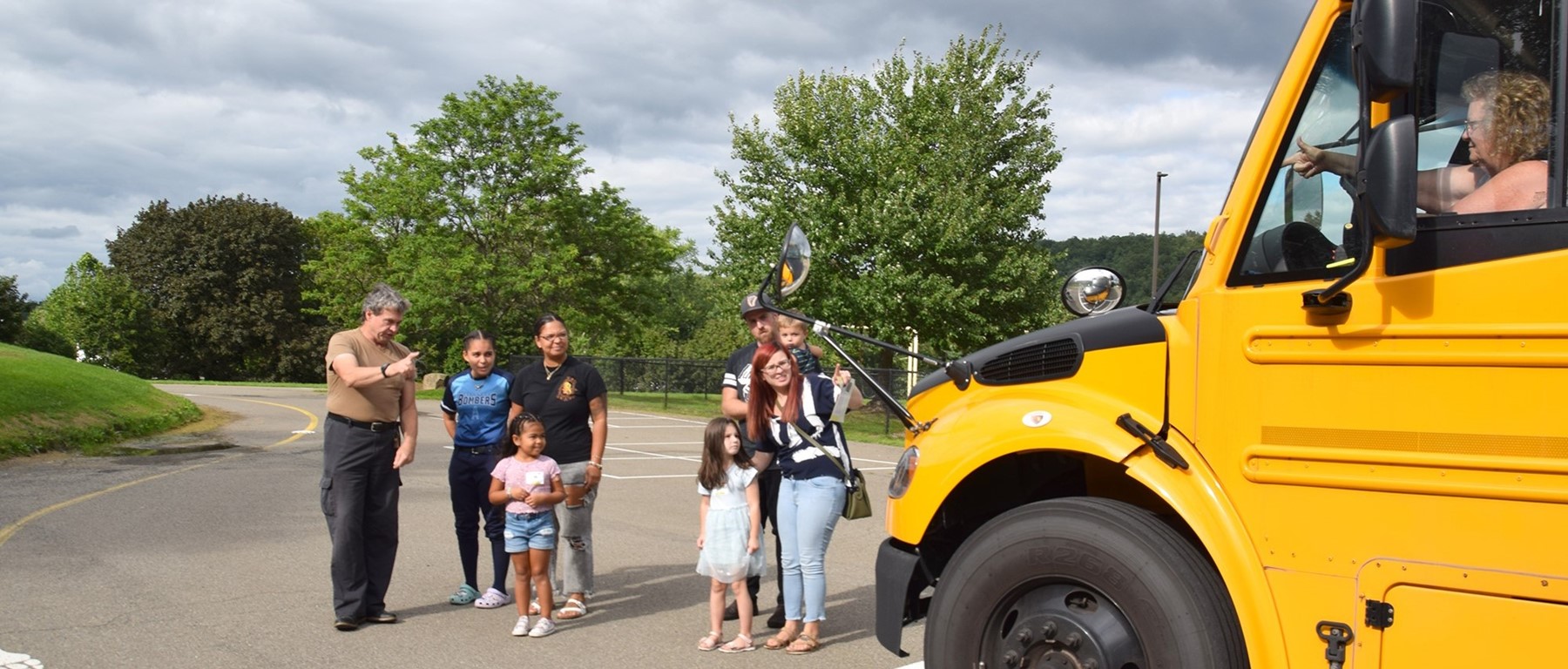 Glenwood kindergarten students and their families learn how to cross safely in front of a school bus during orientation.