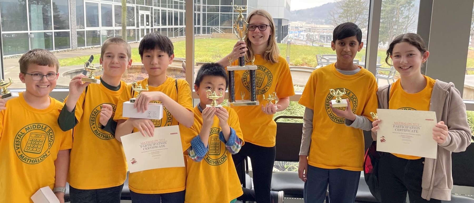 Seven members of the Vestal Middle School&#39;s first-place Mathalon team hold their trophies.