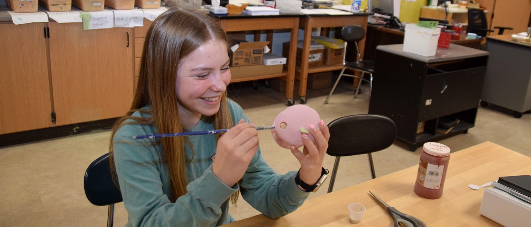 A Vestal Middle School eighth-grade student paints a ceramic project in art class.